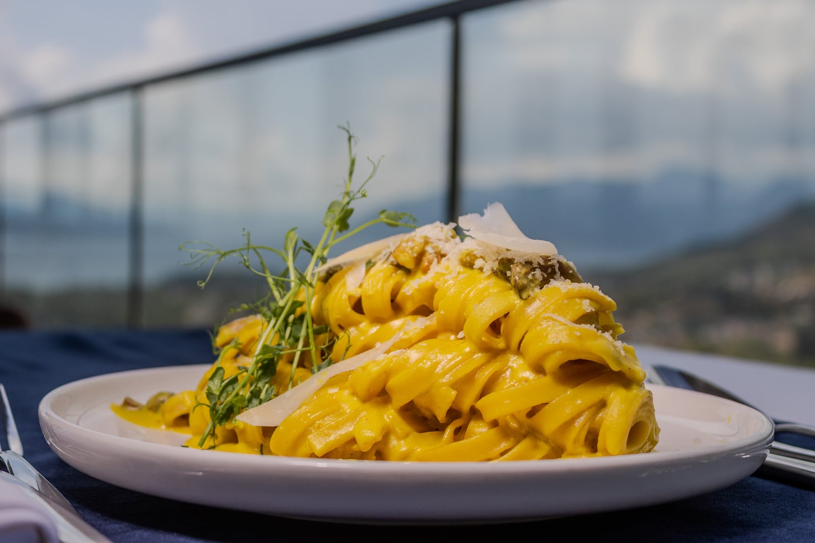 Pasta topped with shaved cheese at Cielo